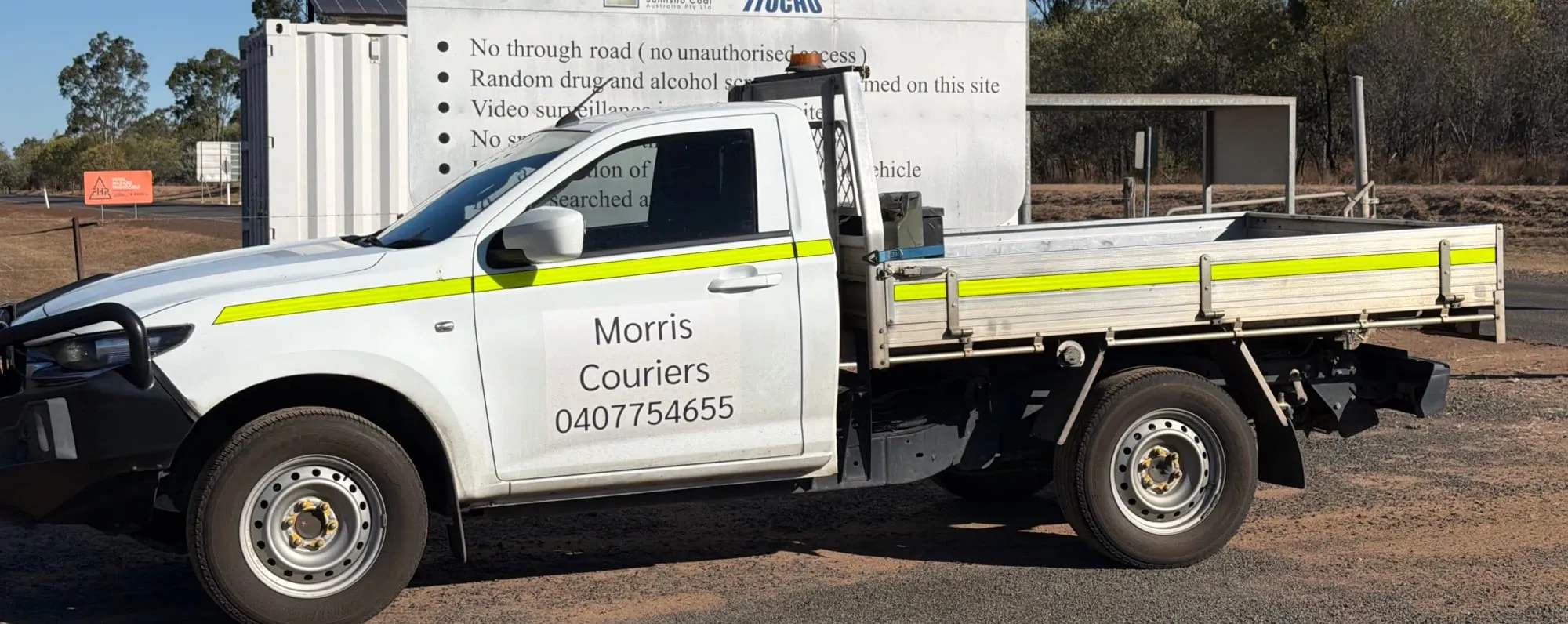 A Morris Couriers ute at a coalfields mine gate west of Rockhampton.